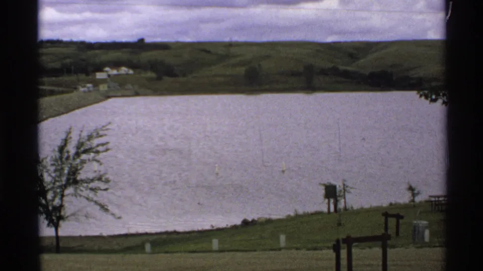 Lake Ashtabula Reservoir in North Dakota seen from a visitor viewpoint, with hills and shoreline features in soft 8mm color.