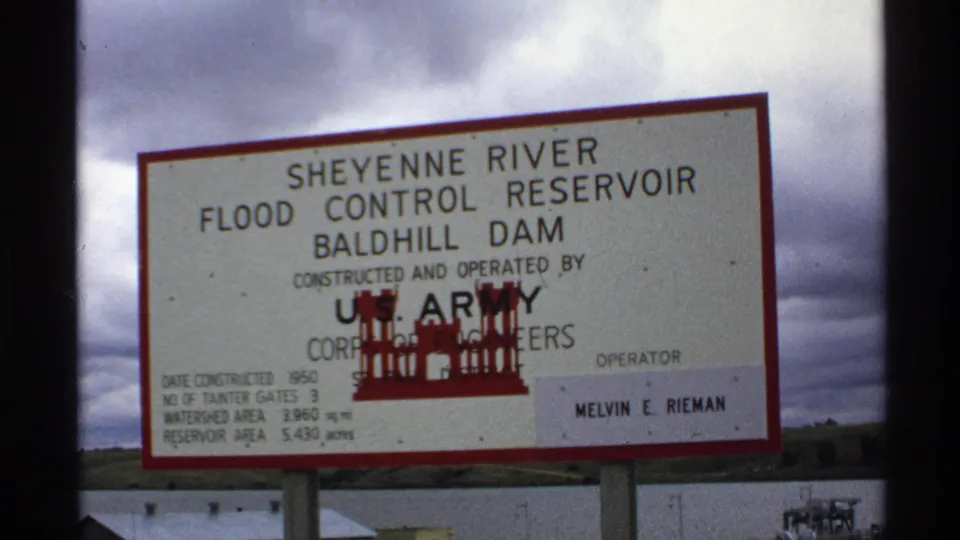 Close 8mm view of the North Dakota Baldhill Dam sign with construction and reservoir details visible.