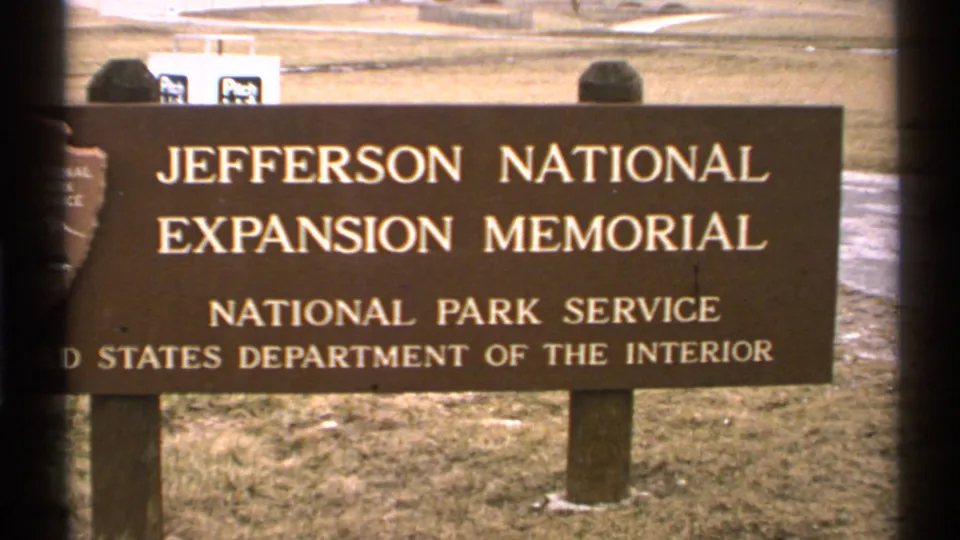 1972 Saint Louis 8mm frame showing the Jefferson National Expansion Memorial sign for the National Park Service.