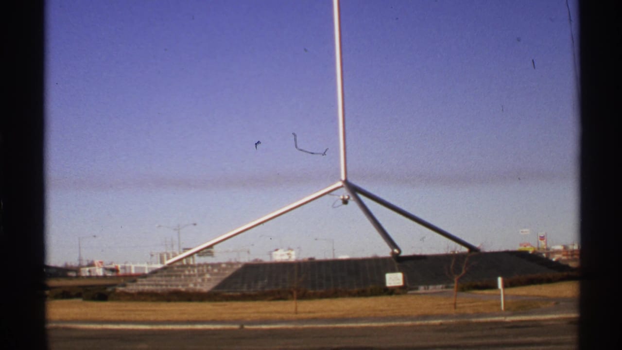 1972 Tulsa 8mm frame showing the Mabee Center area at Oral Roberts University from a roadside vantage.