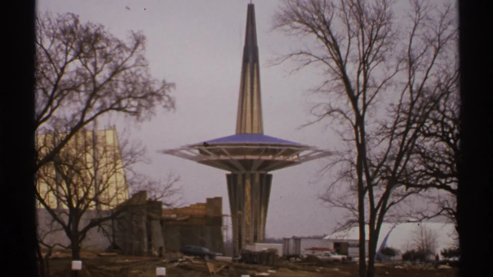 Oral Roberts University Prayer Tower in Tulsa, 1972, viewed across construction grounds with bare trees and small vehicles nearby.