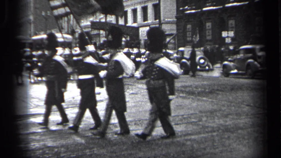 A closer 1937 Cleveland view shows uniformed men marching with raised ceremonial arms, dark coats, tall hats, and street traffic behind them.