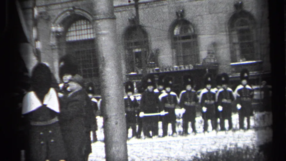 Final frame of the Cleveland ceremony shows soldiers at attention by the building, with spectators and a pole emphasizing the home-movie vantage point.