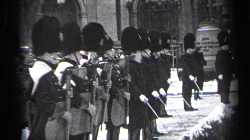 A row of ceremonial guards remains at attention near stone architecture in the Cleveland 1937 home-movie footage.
