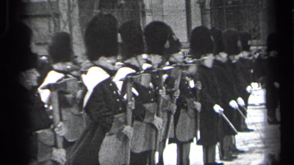 Side view of uniformed ceremonial guards in tall hats during a 1937 Cleveland public street event.