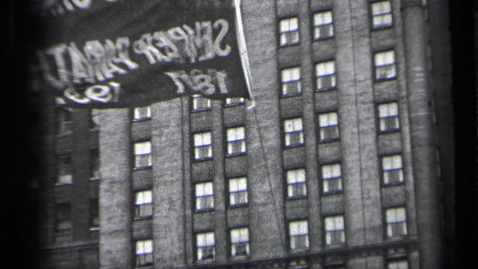 A close view shows part of a Cleveland Semper Paratus 1837 banner against a tall multi-window building.