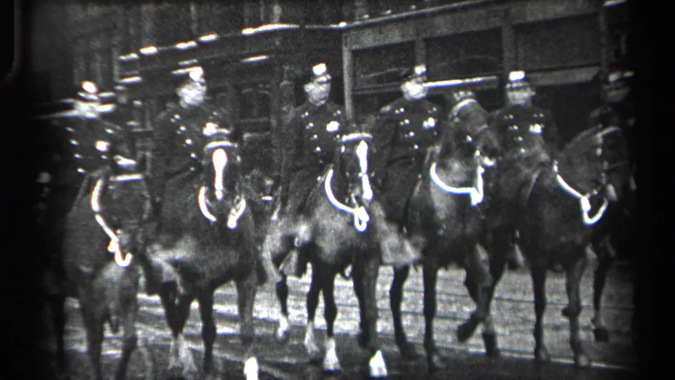 A closer 1937 Cleveland view shows mounted police in dark coats and caps riding horses through an urban street scene.
