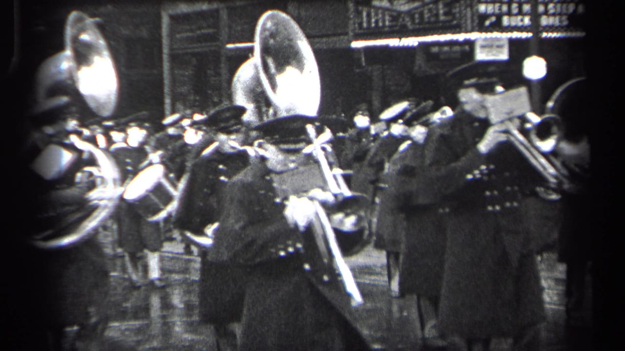 Close view of marching band brass players with large sousaphone bells and trombones.