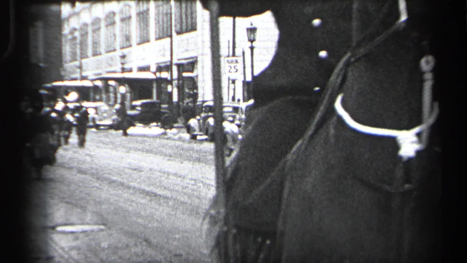 A police horse fills the foreground while vintage cars, pedestrians, buildings, and a 25 mph sign line the Cleveland street.