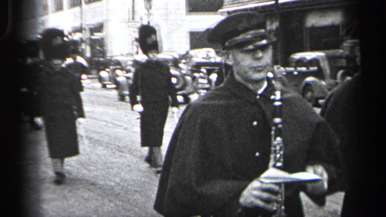 In 1937 Cleveland footage, a uniformed clarinet player stands close to camera as guards in tall hats march behind him.
