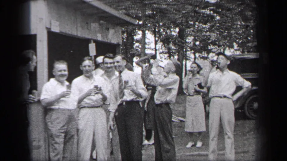 A 1937 Cleveland outdoor break scene shows adults smiling with drinks near a building, trees, and a vintage car.