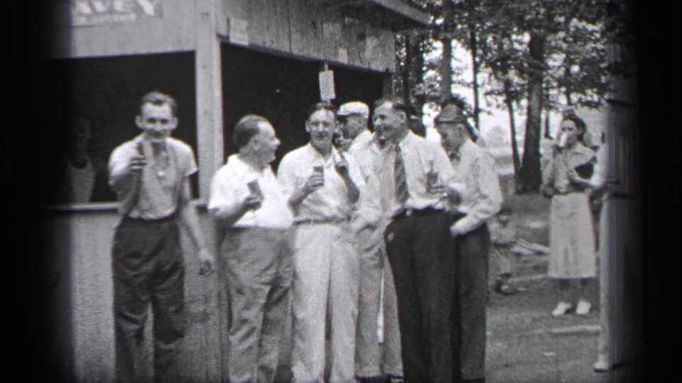 In the supplied 1937 Cleveland setting, several men hold drinks near a wooden booth, with one man smiling toward the camera.