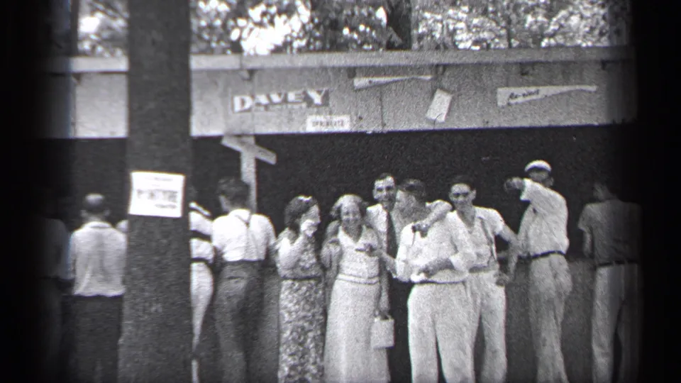 Adults gather at the Cleveland outdoor venue, with several faces visible and the DAVEY sign above the shaded doorway.