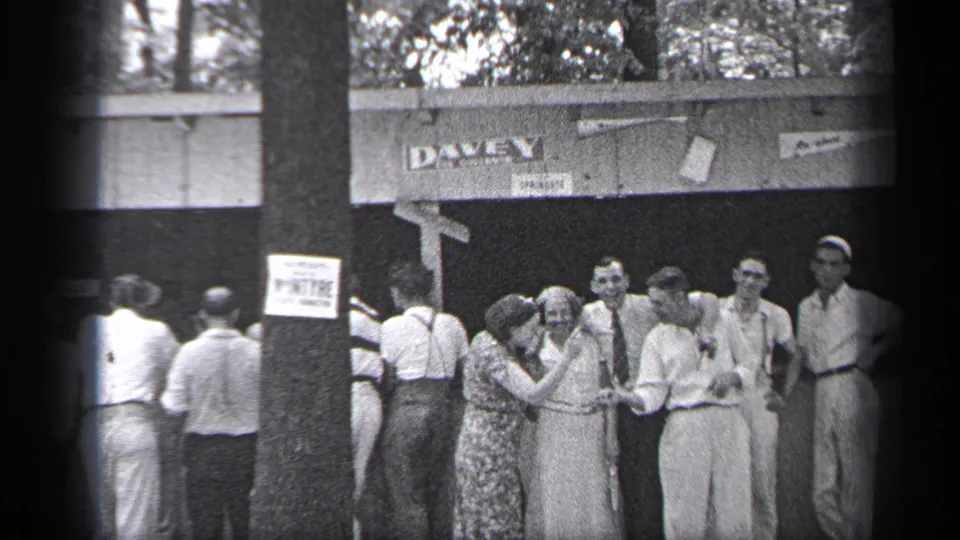 A woman leans toward another adult while several men stand nearby outside the DAVEY-marked Cleveland venue.