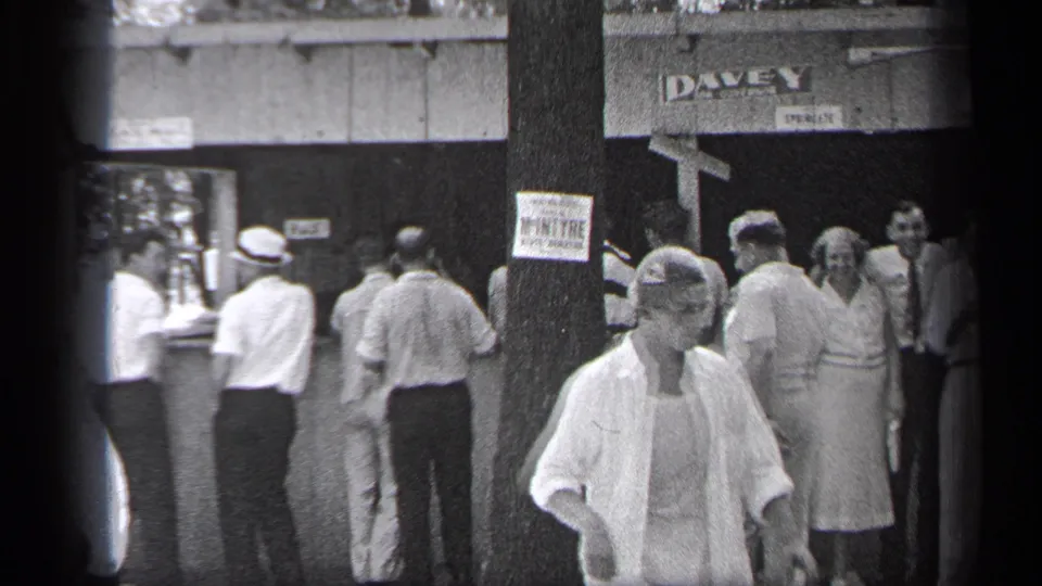 The final 1937 Cleveland frame keeps the crowd at the DAVEY entrance in view while a light-clothed adult passes through the lower foreground.