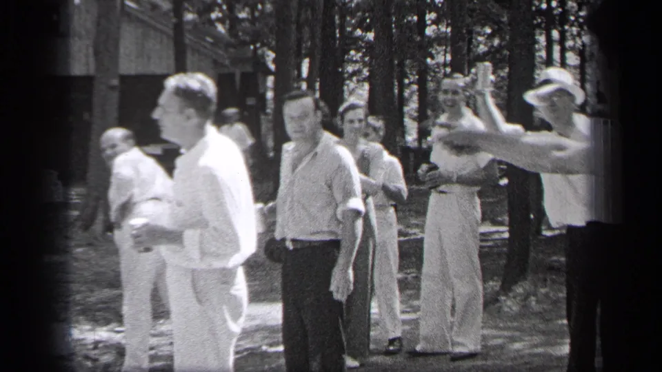 A group of adult men in a Cleveland park appear to talk and gesture during a 1937 outdoor gathering.