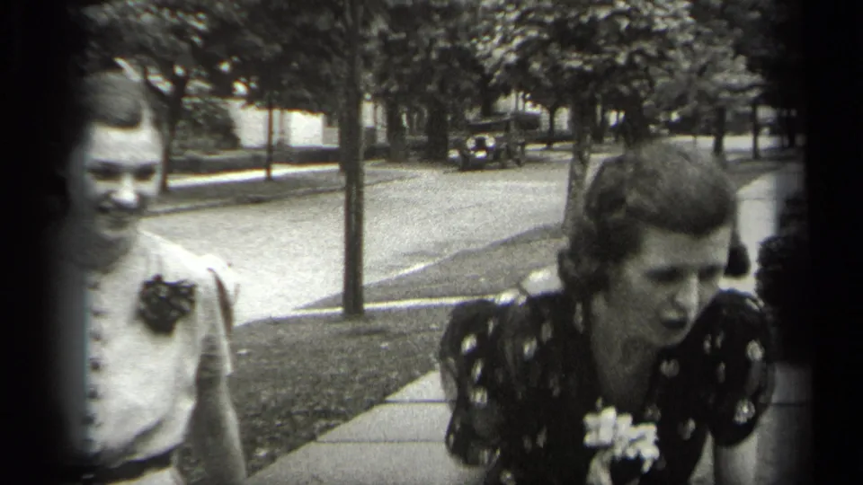 In the Cleveland street scene, the two women move close to the 8mm camera, their faces and dresses partly cropped by the frame.