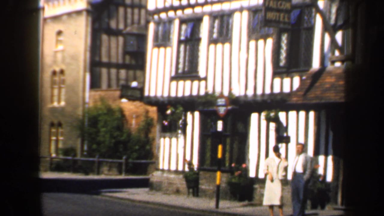 The Falcon Hotel exterior with two pedestrians on the street.