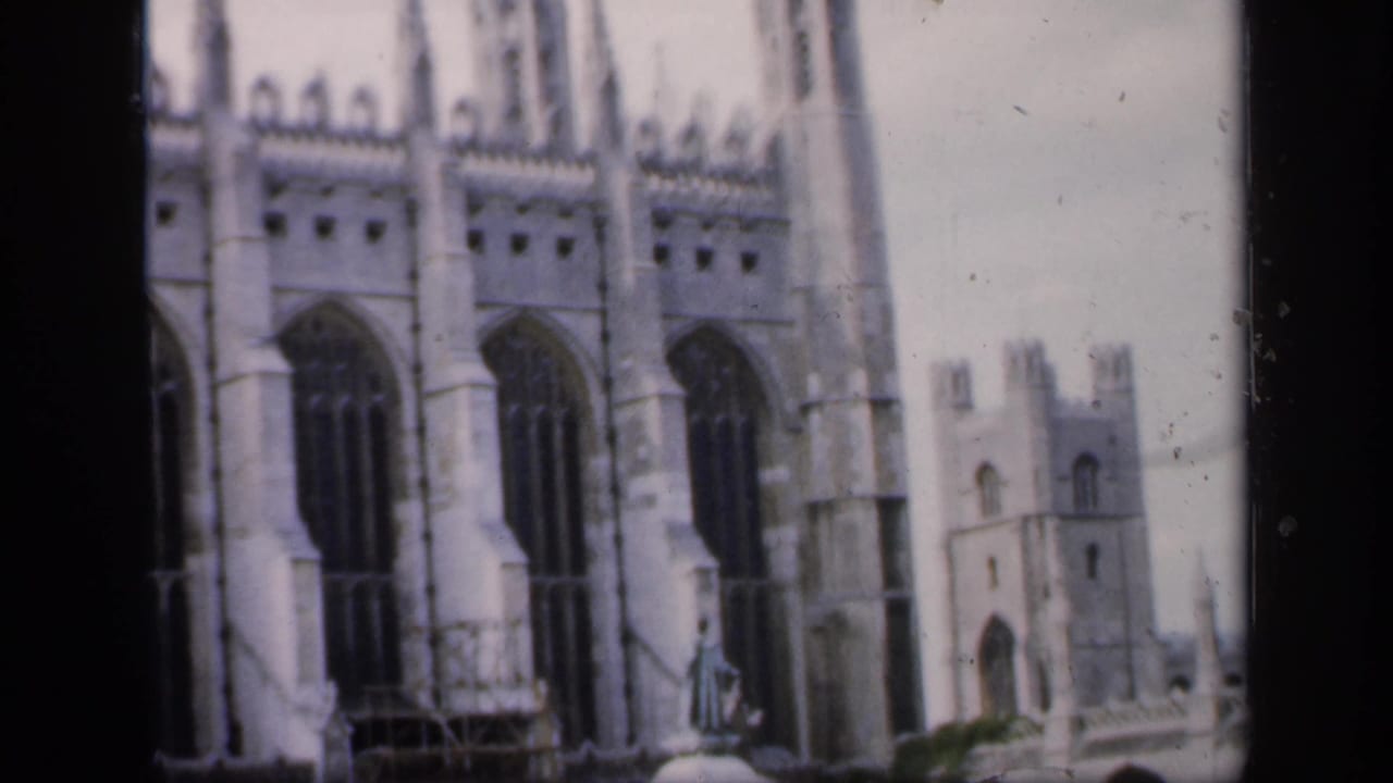 Gothic church facade with tall arched windows and scaffolding near the lower stonework.
