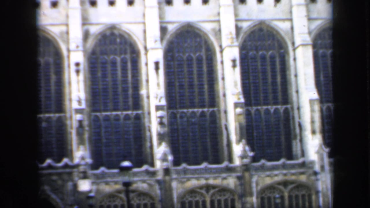 Close view of arched church windows and stone tracery.