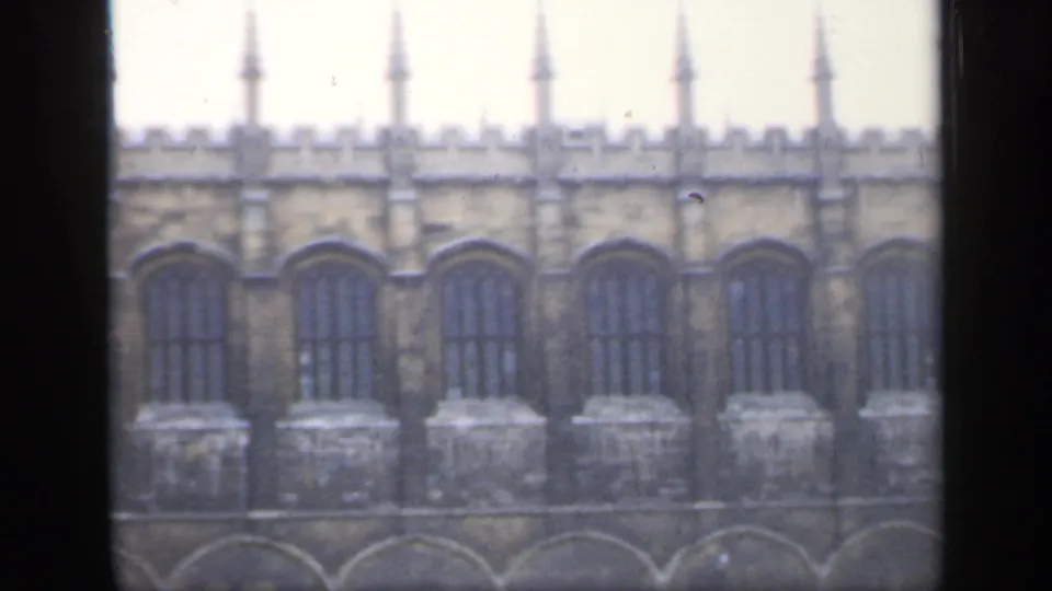 The final 1949 England frame shows a longer section of the castle-like stone building, including crenellations, tall windows and roofline spires.