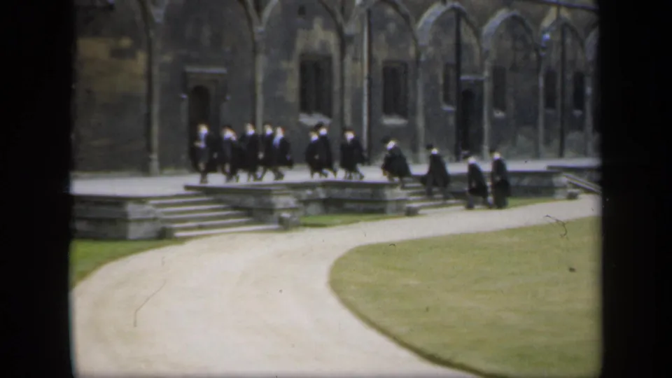 The final frame shows robed academic figures moving beside stone steps and arched windows, with lawn and path in the foreground.