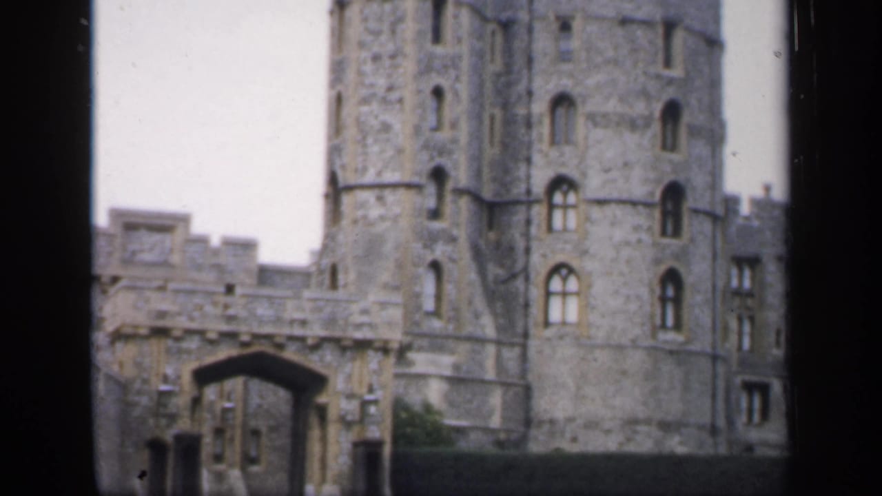 Closer view of castle gateway and cylindrical tower with dark film border.