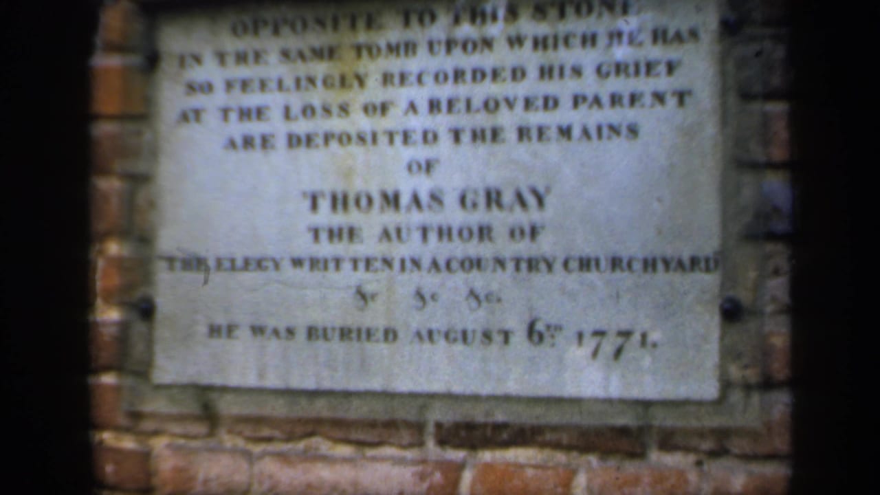 Close view of a Thomas Gray memorial plaque set into a brick wall.