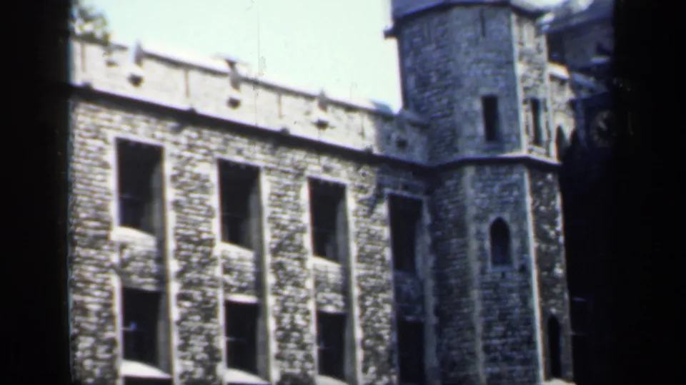 Historic stone architecture in England, filmed from a shaded or obstructed visitor viewpoint on 8mm color film.