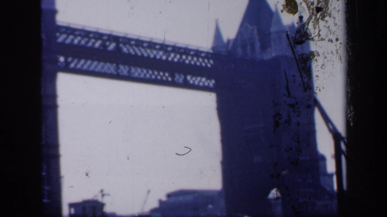 Tower Bridge upper walkway and right-side tower silhouette against a pale sky.
