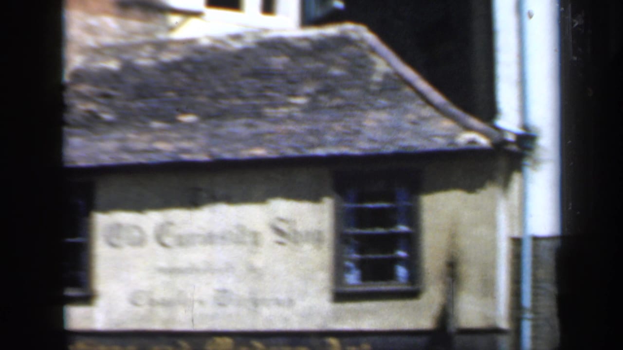 Side view of the Old Curiosity Shop building with painted wall lettering.