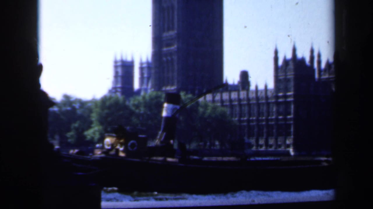 1949 London river view of the Palace of Westminster and Elizabeth Tower, partly framed by dark foreground edges.