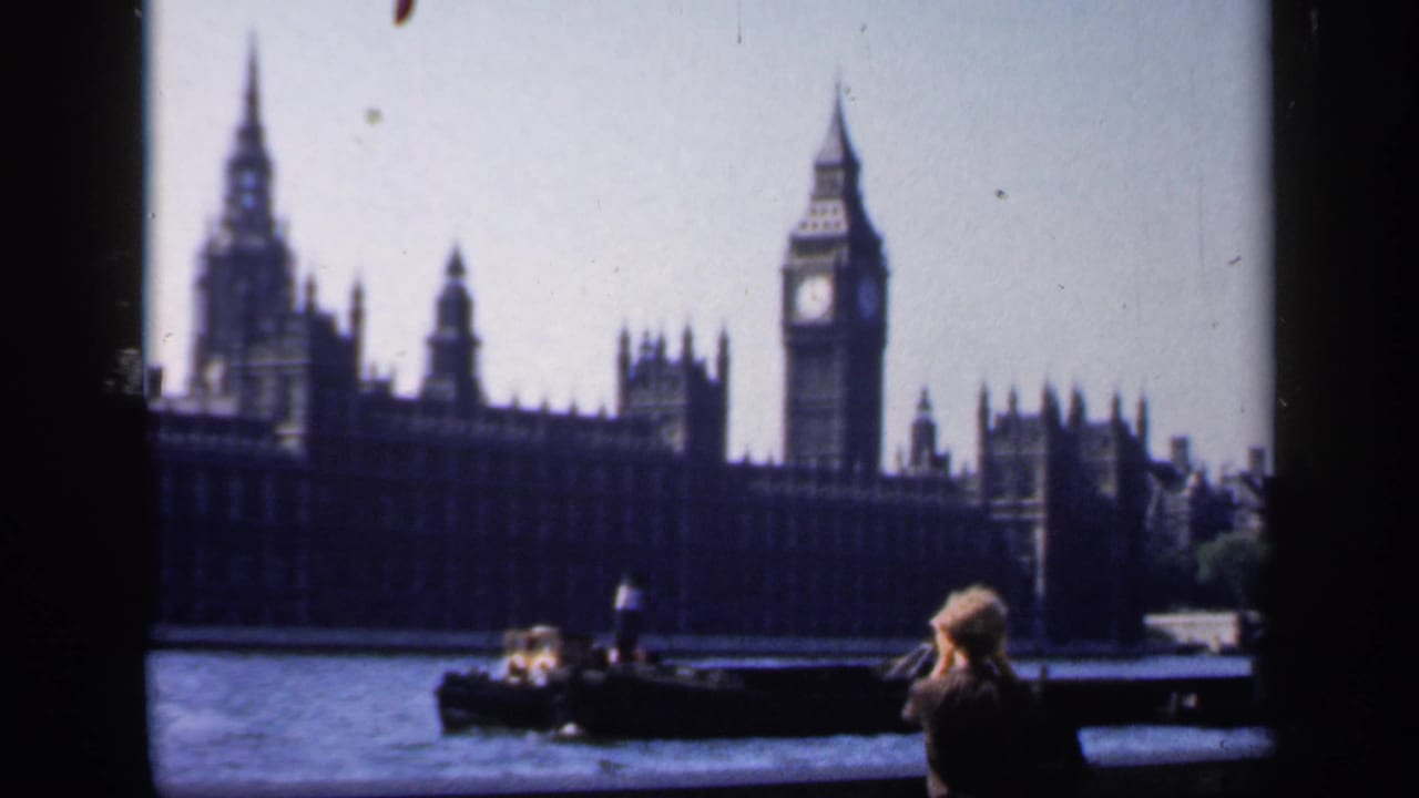 1949 London home-movie view of Big Ben and the Houses of Parliament from across the Thames, with tourists in the foreground.