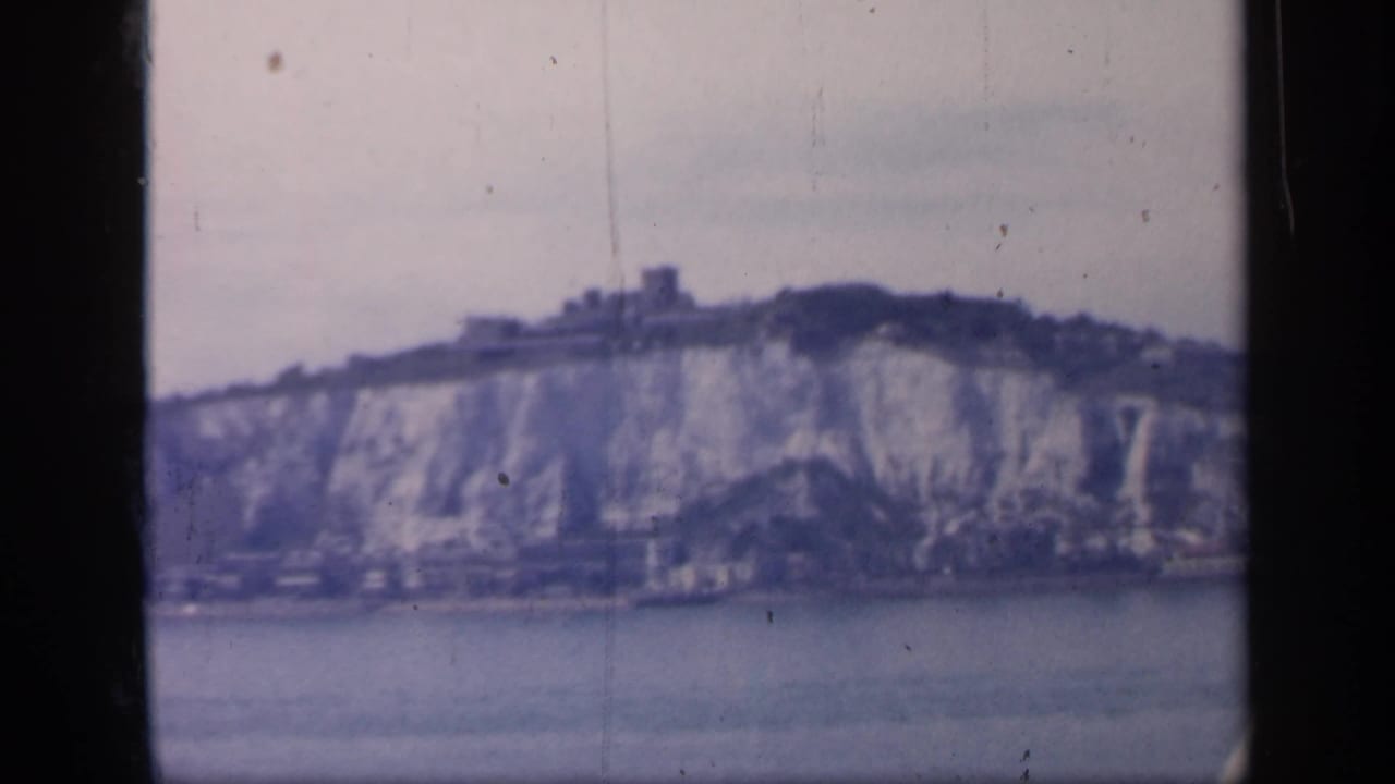 A slightly lower 8mm view shows the Dover cliff face, ridge-top castle and shoreline structures beyond the water.