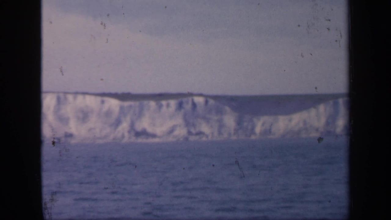 1949 England 8mm frame showing a continuous wall of white chalk cliffs above the sea, with no people visible.