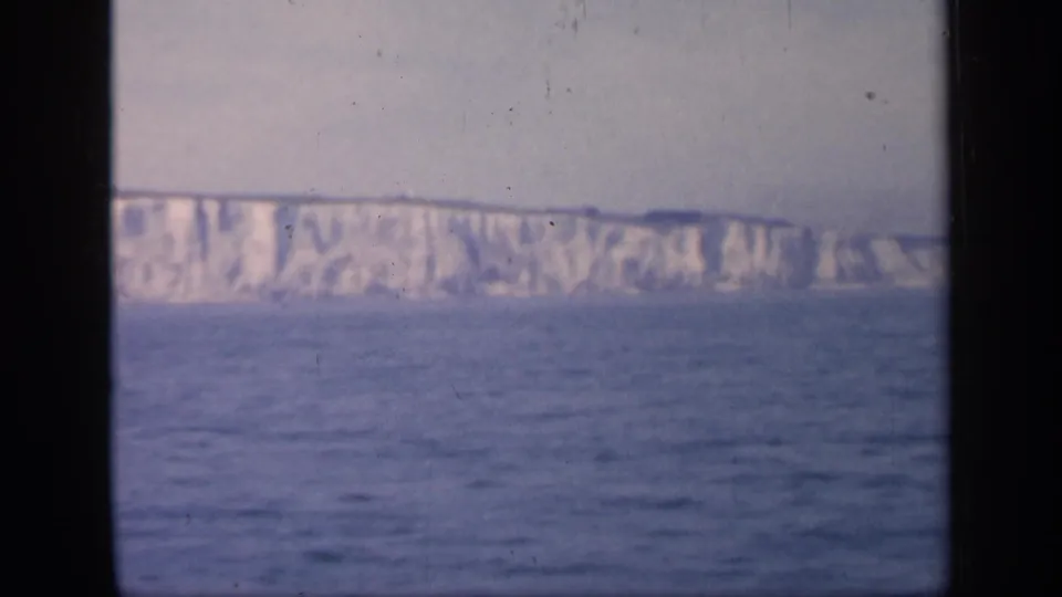 English white cliffs appear in a soft 8mm seascape, with open water in front and a pale sky above.