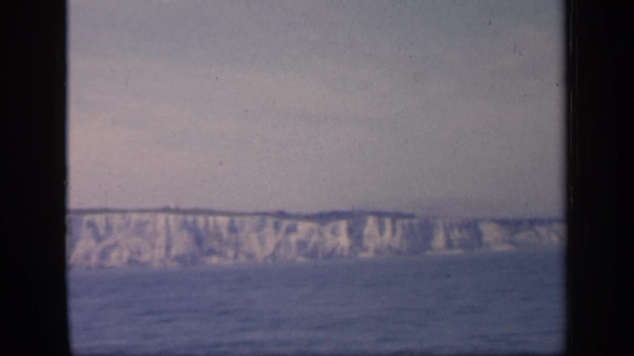 1949 England coastal footage shows pale chalk cliffs stretching across the distance, with muted 8mm color and visible film wear.