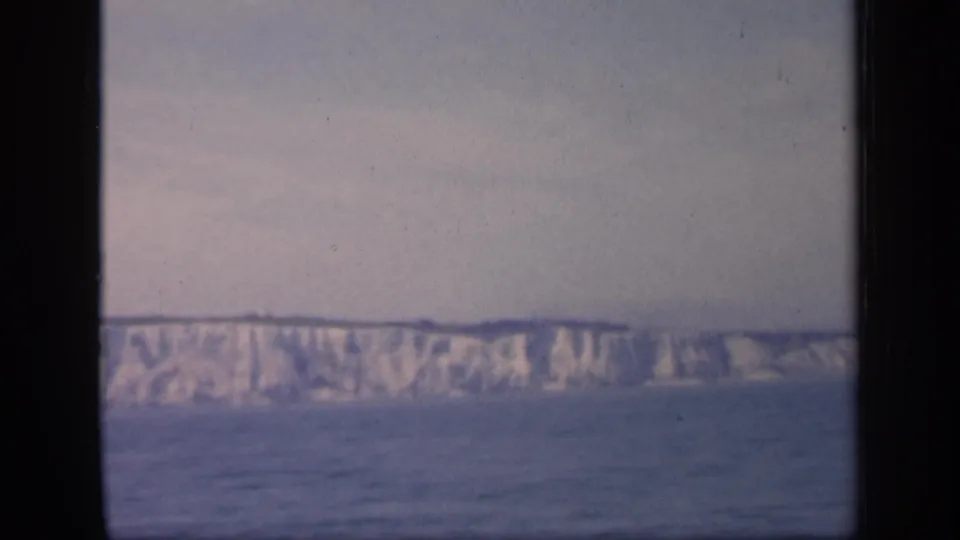 1949 England coastal footage shows pale chalk cliffs stretching across the distance, with muted 8mm color and visible film wear.