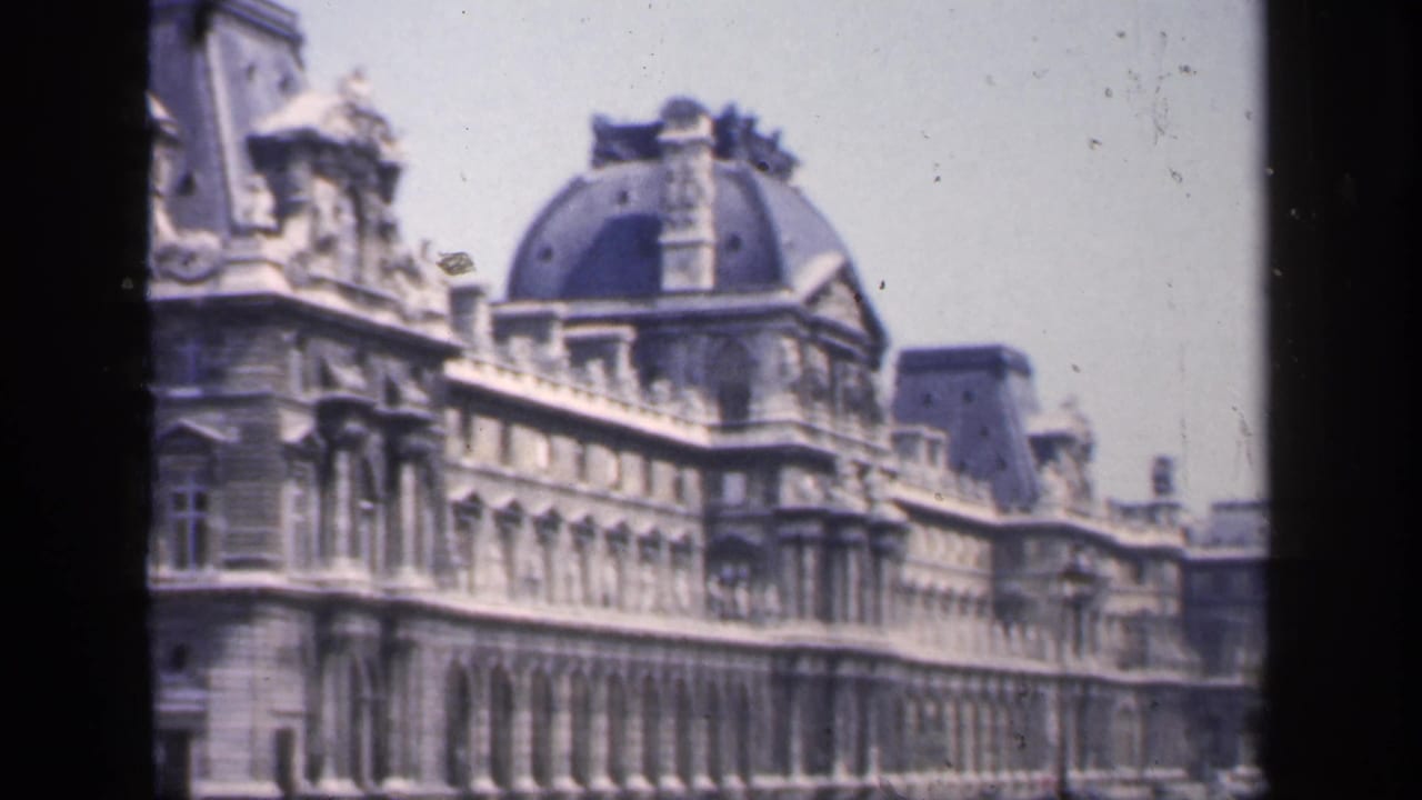 Ornate Parisian stone facade with domed roof seen through 8mm frame borders.