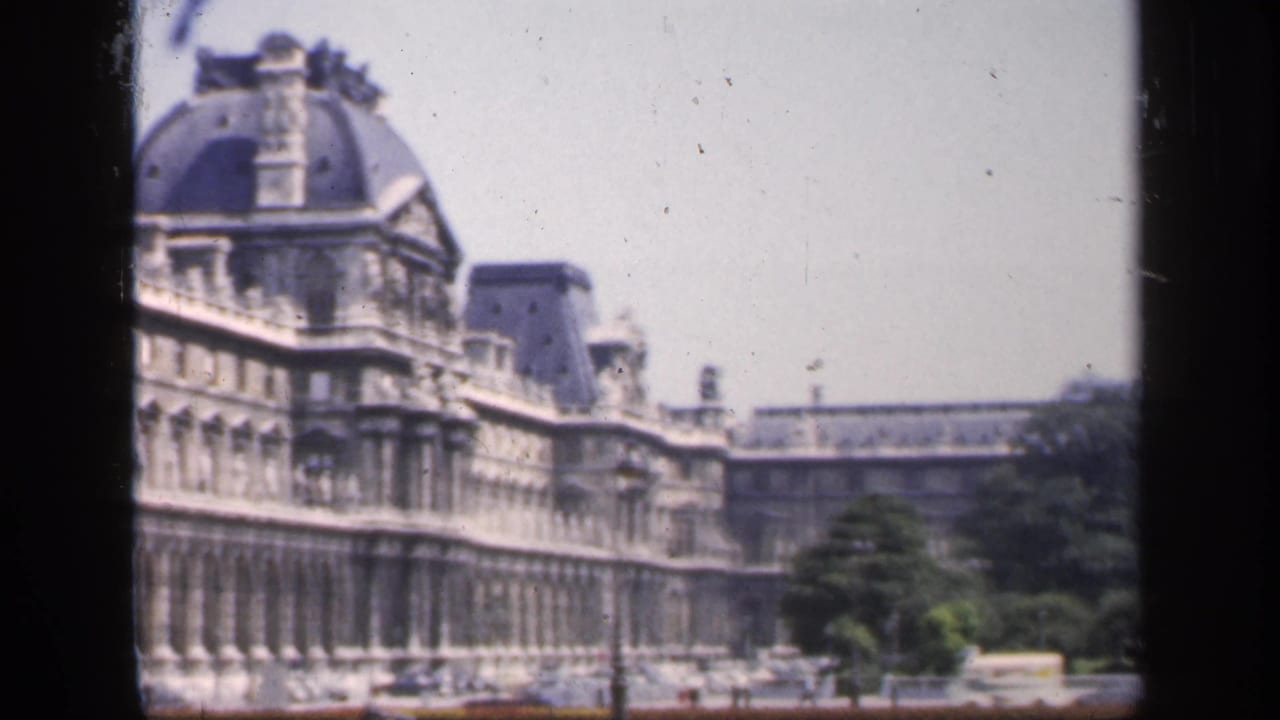 1949 France 8mm frame showing the landmark facade extending across the view, with a domed pavilion and trees below.