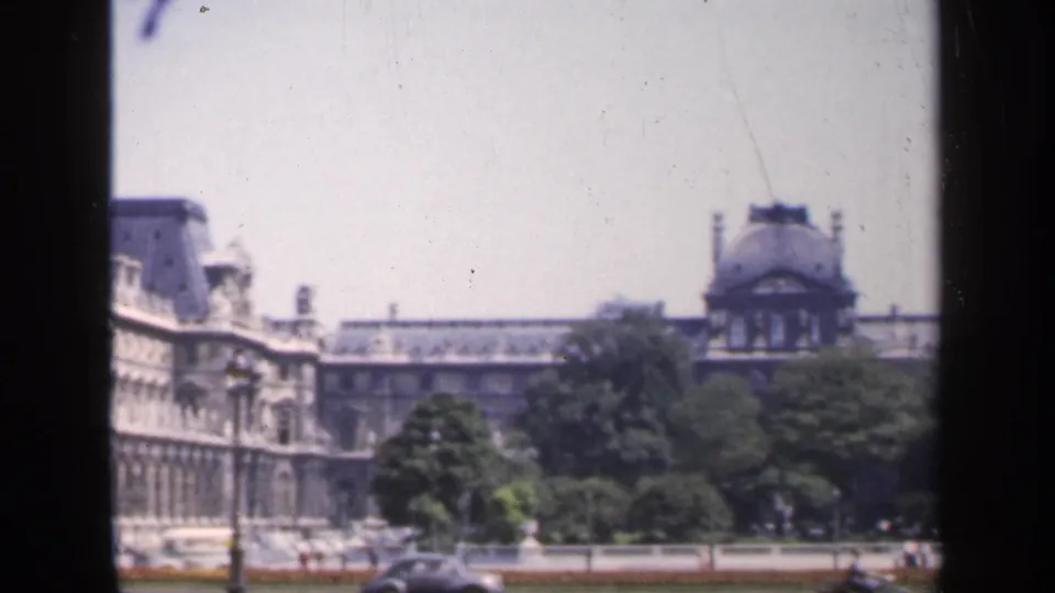 1949 France 8mm frame with the pan shifting from the ornate facade toward trees and another domed section of the complex.