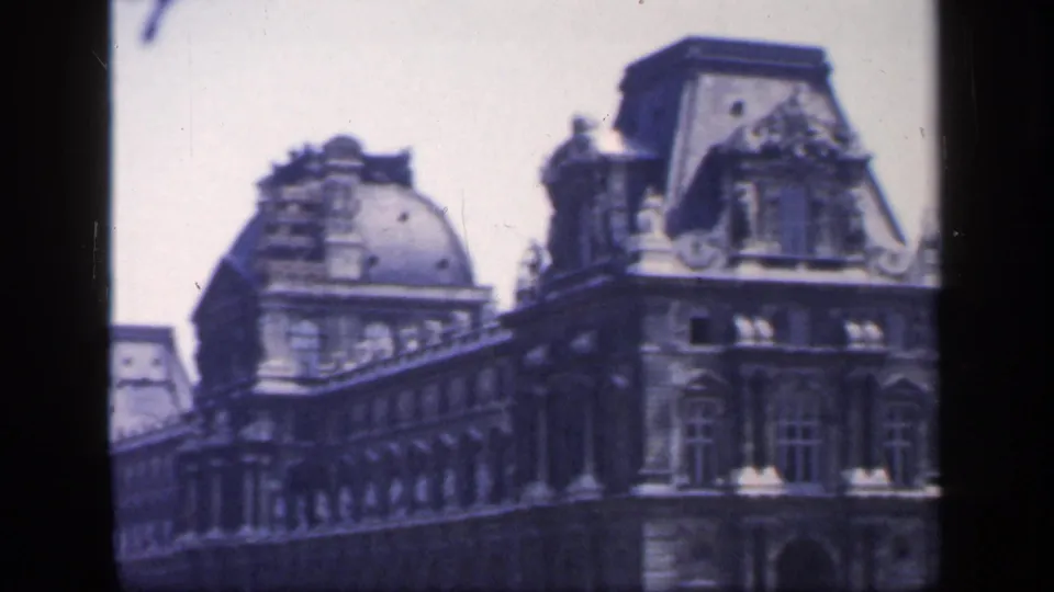 Closer 1949 France frame of a historic stone building with domed roof details, windows, and dark film or window borders.