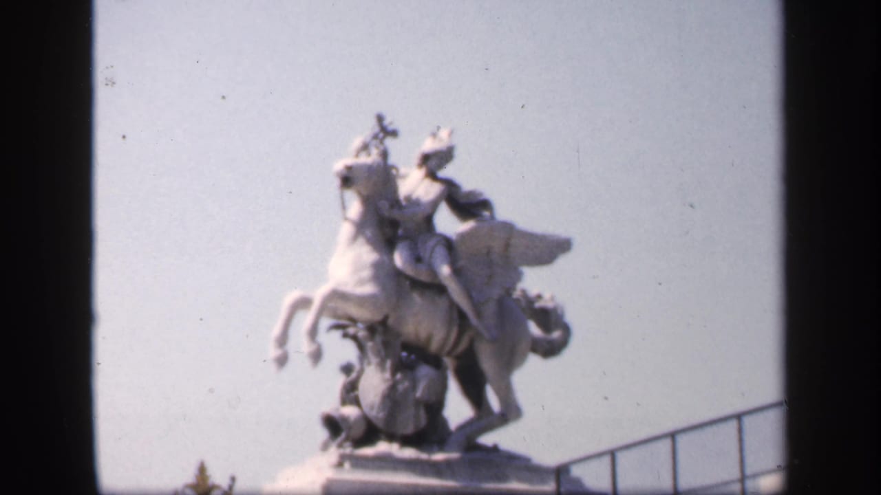 Soft close view of a pale equestrian statue against a bright sky.