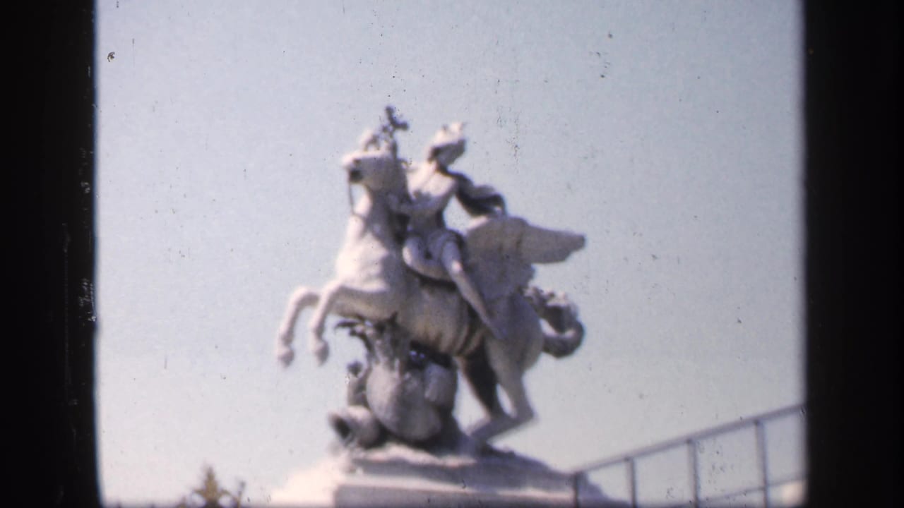 Similar close view of the equestrian statue with railing and sky.