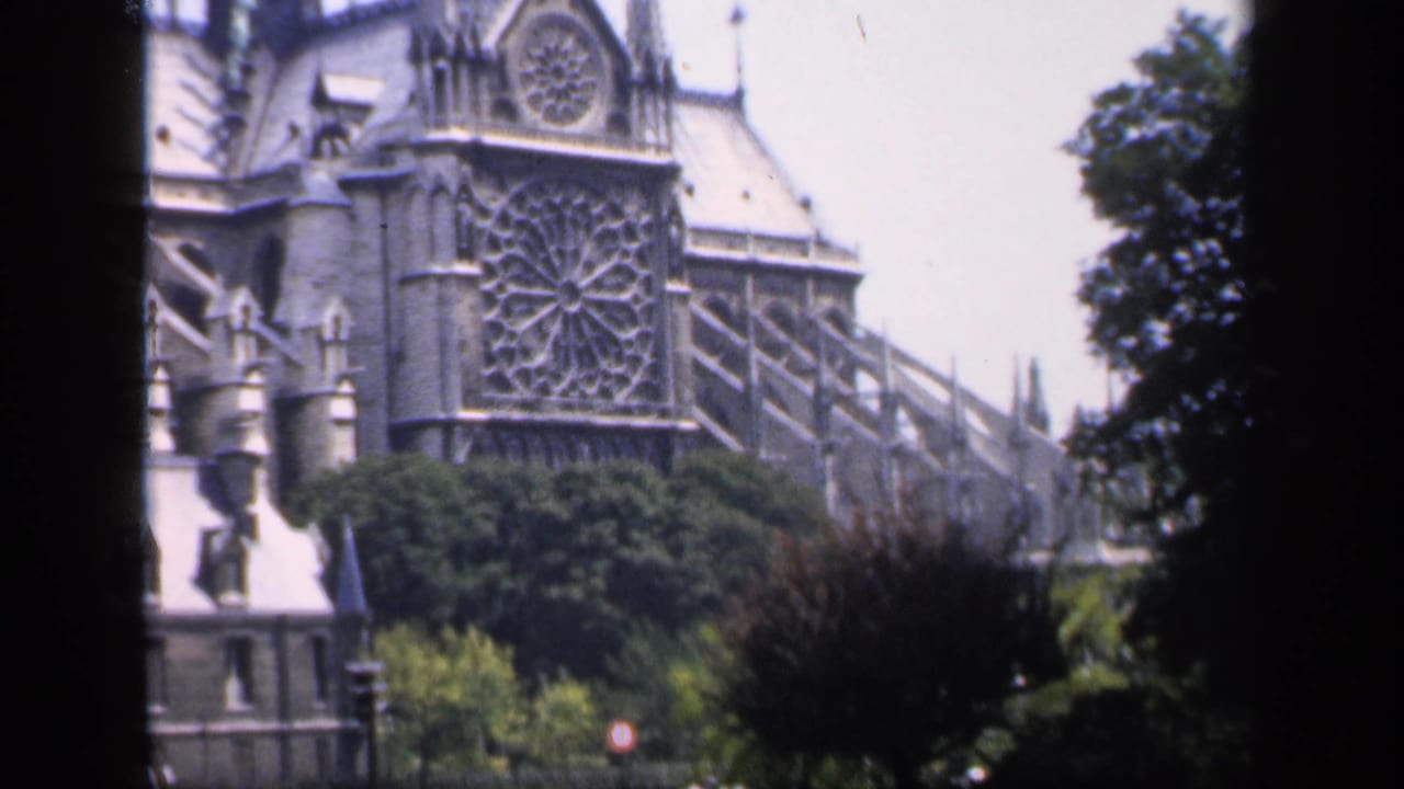 Notre Dame exterior seen beside a dark vertical film edge.