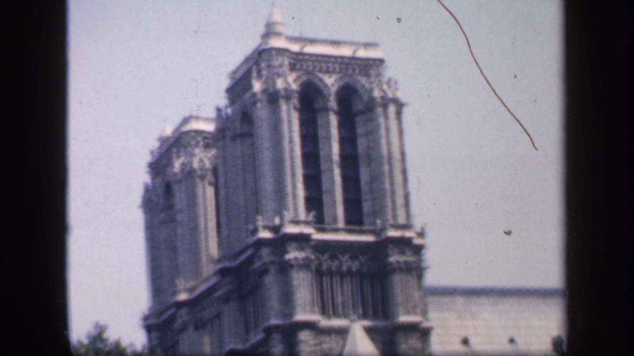 Notre-Dame Cathedral tower seen in soft focus with dark film-frame borders.