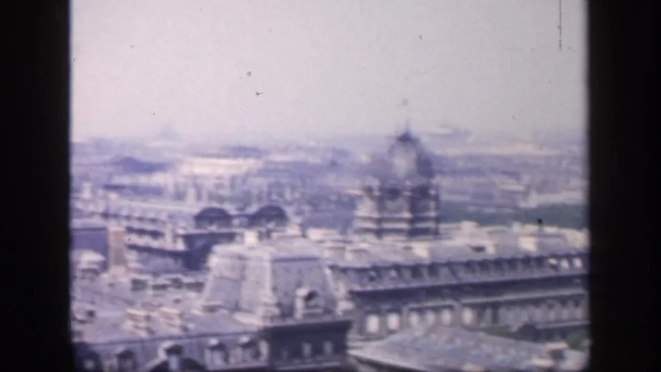 End frame of the 1949 France city view, with soft rooftops, a rounded roof detail, distant haze, and visible dark film edge.