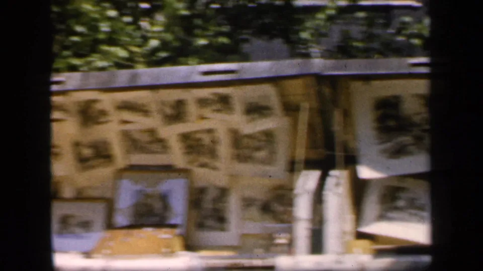 1949 New York City street-level view of a newsstand display with newspapers, framed pictures, and a canopy edge.