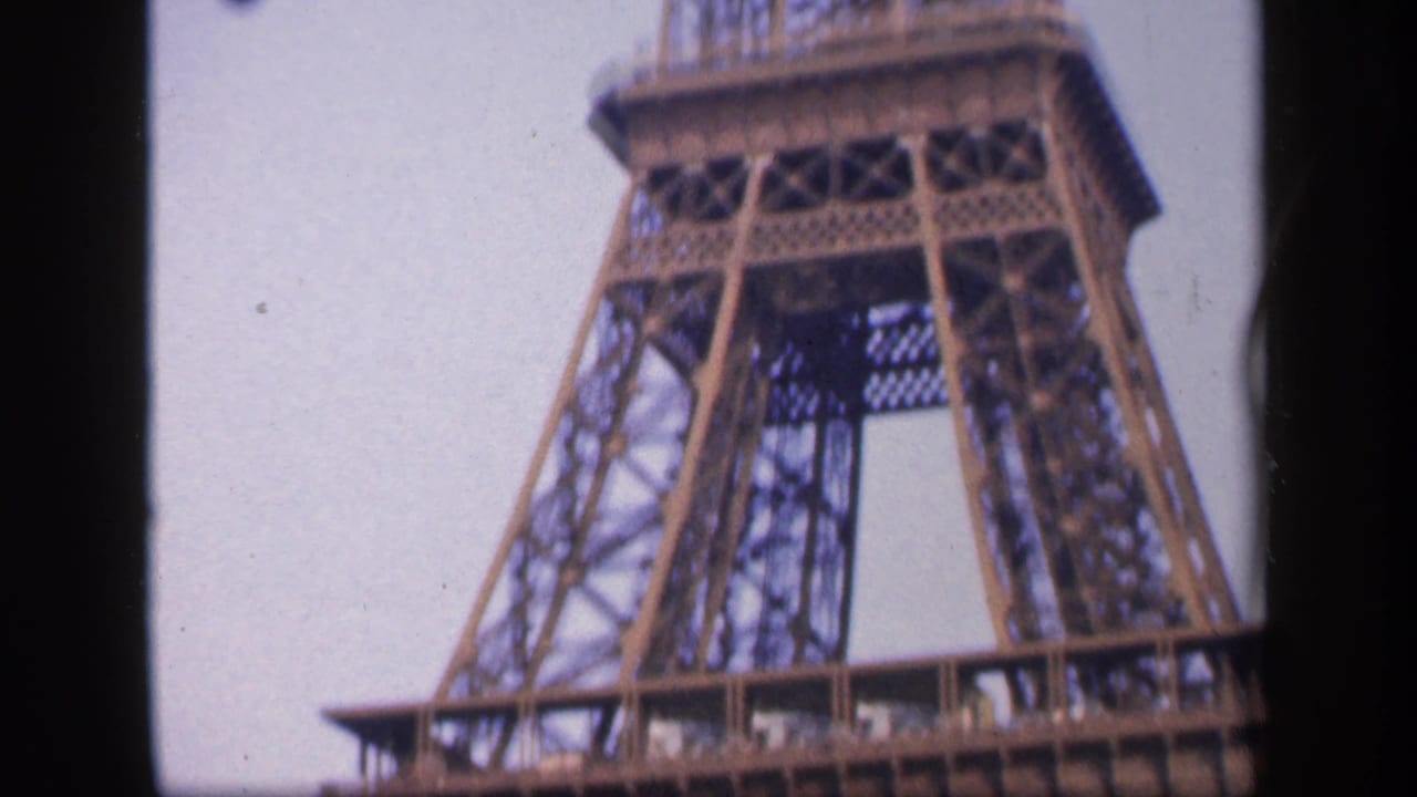 1949 Paris 8mm frame showing the Eiffel Tower lower platform and vertical lattice supports during an upward pan.