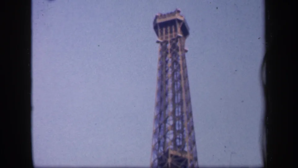 1949 Paris frame showing the upper Eiffel Tower and top platform near the end of the upward pan.